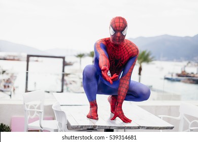 TIVAT, MONTENEGRO - AUG 4, 2015:  Cosplayer Dressed As Spiderman In Cafe Of TIvat. Spider Man Is A Fictional Character Created By Stan Lee