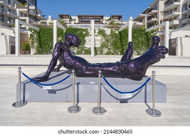 TIVAT, MONTENEGRO - JULY 15, 2021: Sculpture Of A Lying Man With Big Legs, Modern Art Installation