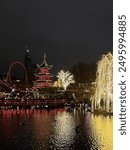 Tivoli lights in rollercoaster, building, and trees