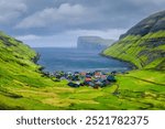 Tjornuvik village, Streymoy Island, Faroe Islands, Denmark. Scenic place for travel. Panoramic view of the village, sea bay and mountains. Photography for wallpaper and postcards.