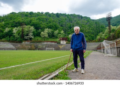 Tkibuli, Racha Lechkhumi Region/ Georgia - 05.20.2019: 100 Years Old Man Training On Abandoned Sports Stadium In Mining Town Tkibuli. 