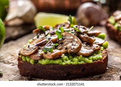 Toast Avocado, Mushrooms And Microgreen Whole Grain Sandwich. Decorated With Sesame. Vegetarian Food. Vegan Menu. Delicious Breakfast Or Snack, Clean Eating, Dieting, Vegan Food Concept. Top View.