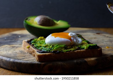 Toast with avocado and poached egg and Vegemite