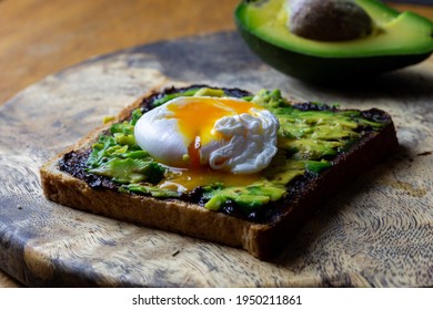 Toast with avocado and poached egg and Vegemite