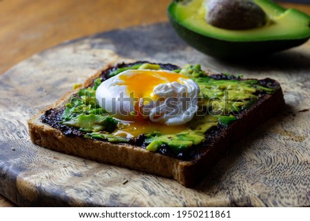 Toast with avocado and poached egg and Vegemite