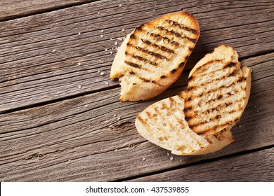 Toast Bread With Salt On Wooden Table. Top View With Copy Space