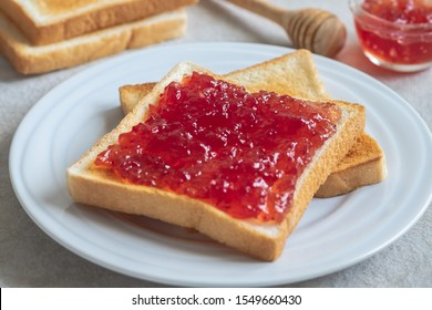 Toast bread with strawberry jam on plate

