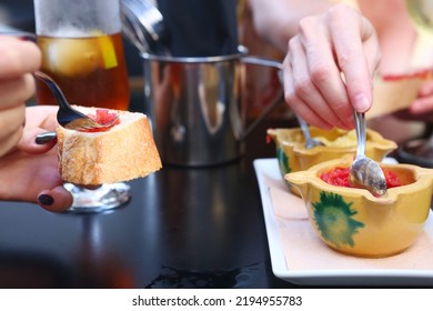 Toast Bread With Tomato And Garlic Aioli Sauce Close Up Photo With Human Hands On Outdoor Restaurant Background