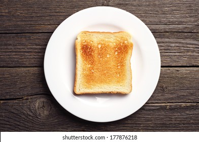 Toast Bread In A White Plate On Vintage Wooden Background. Top View