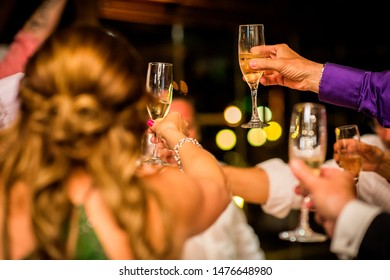 toast with champagne at a restaurant celebration - Shutterstock ID 1476648980