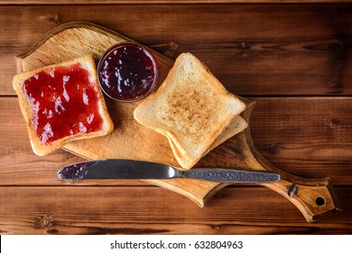 Toast With Cherry Jam On Rustic Wooden Cutting Board. Close Up. Top View.