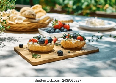 Toast with cream cheese, blueberry, strawberry, coconut flakes and herbs for summer picnic or brunch. Sweet mini sandwiches for healthy breakfast in the garden. - Powered by Shutterstock