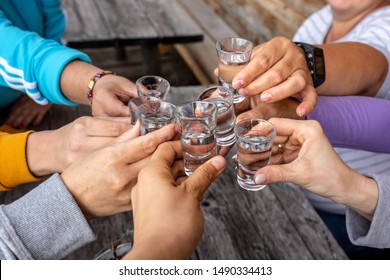 toast with friends with spirits shots - Powered by Shutterstock