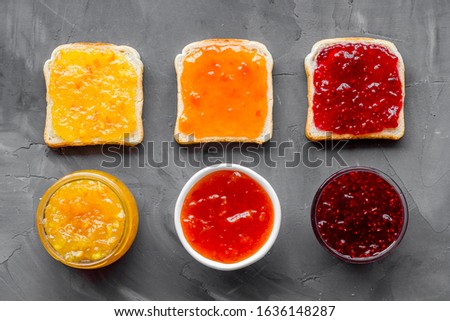 Toast with jam pattern on grey background flat lay