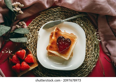 Toast with jam in the shape of a heart.
Conceptual Valentine's day, love, romanticism