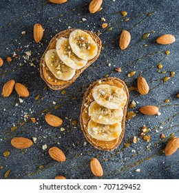 Toast With Peanut Butter, Banana And Almond Nuts. Diet Natural Breakfast. Flat Lay, Top View