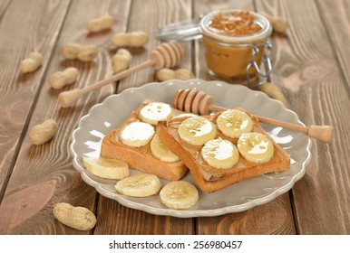 Toast With Peanut Butter And Banana On A Brown Table