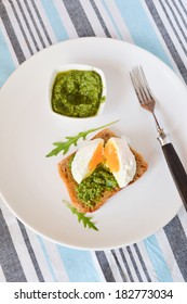 Toast With Pesto Of Arugula With Poached Egg