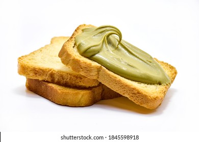 toast with pistachio cream lying on plain toasts isolated on white. - Shutterstock ID 1845598918