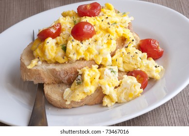 Toast With Scrambled Eggs And Cherry Tomatoes