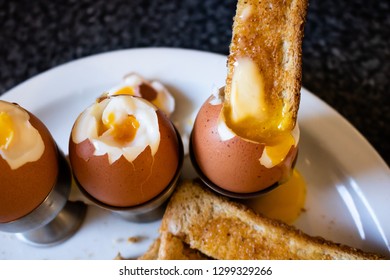 A Toast Soldier Dipped Into A Runny Soft Boiled Egg