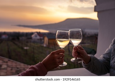 Toast With Wine Glasses At Lake Balaton With The Badacsony Hill In The Background .
