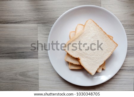 Toasted 3 slice of bread on white plate , Wide angel on the table , Selective focus