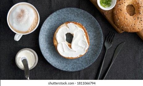 Toasted Bagel With Cream Cheese And Cup Of Coffee For Breakfast, Top View