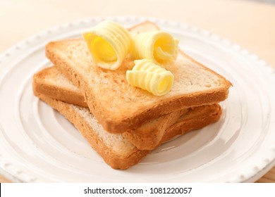 Toasted Bread With Butter Curls On Plate, Closeup