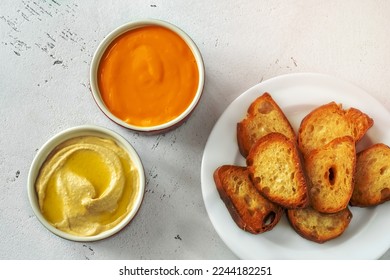 Toasted bread with cheddar sauce and hummus - Shutterstock ID 2244182251