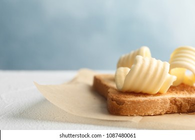 Toasted Bread With Fresh Butter Curls On Table, Closeup