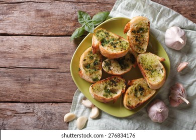 toasted bread with garlic and herbs on a plate. view from above horizontal, rustic style  - Powered by Shutterstock