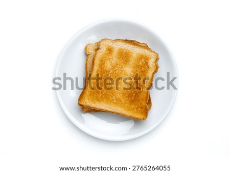 Toasted bread slices served on white plate. Top view and isolated on white background. Breakfast, simple meal, minimal food styling and everyday nutrition