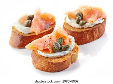 toasted bread with smoked salmon fillet and cream cheese isolated on white background