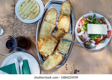 Toasted Breads,feta Chees And Greek Salad Whit Red Wine  As It Served On , Greece,top View