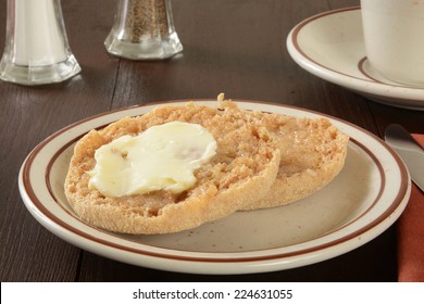 A Toasted And Buttered Whole Grain English Muffin With A Cup Of Coffee