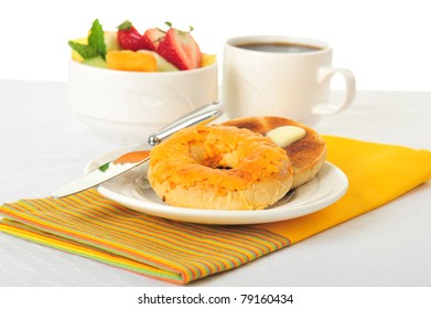 Toasted cheese bagel served with fresh fruit and coffee. - Powered by Shutterstock