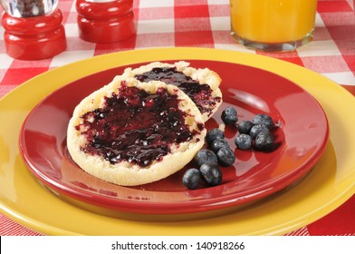 A Toasted English Muffin With Fresh Blueberry Jam