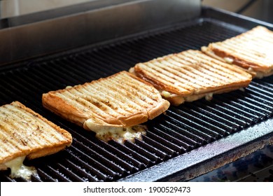 Toasted Sandwiches With Melting Cheese On Toast Machine Or Grill.