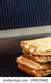 Toasted Sandwiches With Melting Cheese On Toast Machine Or Grill.