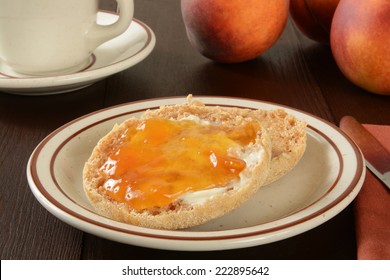 A Toasted Whole Grain English Muffin With Peach Jam And Coffee