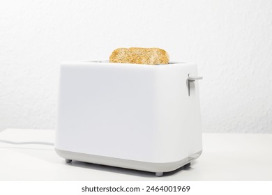 toaster with bread inside on the table. breakfast, lunch. slices of bread. toaster bread.