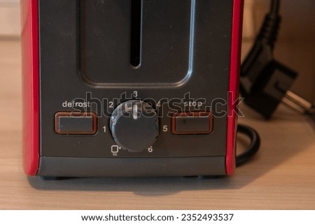 Toaster control dial with defrost and stop.