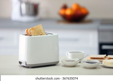 Toaster With Dishes On A Light Kitchen Table