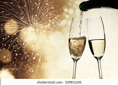 toasting with champagne glasses on sparkling holiday background