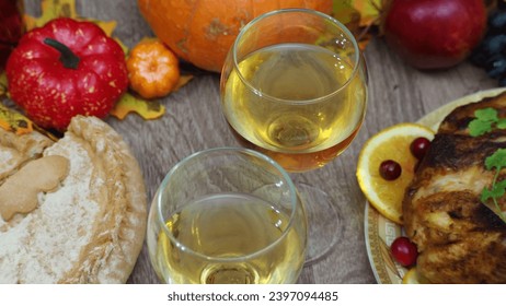 toasting with wine glasses in front of chicken dinner, pour wine, festive dinner at home. chicken. pie, fruits, grapes, apples, pumpkin. Roasted Turkey. Thanksgiving table served . Christmas dinner. - Powered by Shutterstock