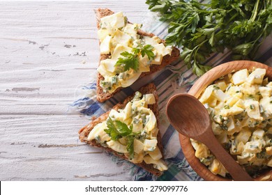 Toasts And Egg Salad With Herbs And Mayonnaise Close-up. Horizontal View From Above 