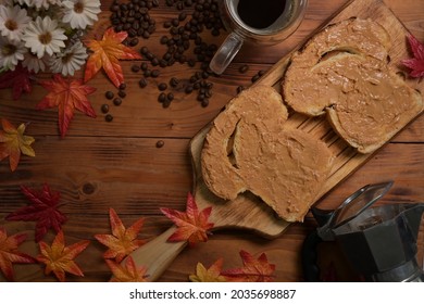 Toasts With Peanut Butter And Coffee Cup On Wooden Table, Overhead View.