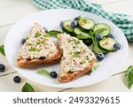 Toasts with tuna. Italian toasts sandwiches with pate canned tuna, egg and cucumber.