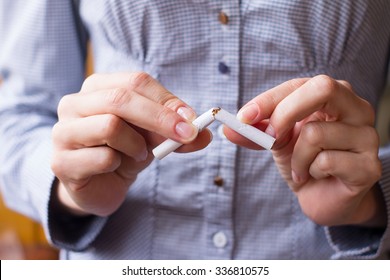 Tobacco addiction. Nicotine smoke. Girl brakes cigarette. Unhealthy, danger, bad, narcotic habit. White filter. Health risk, cancer illness. Quit, stop toxic drug. Lifestyle concept. Pack in hand. - Shutterstock ID 336810575